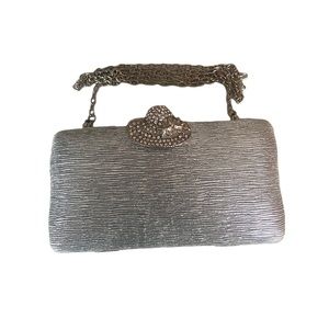 Small silver evening clutch with sun hat clasp and silver chain strap